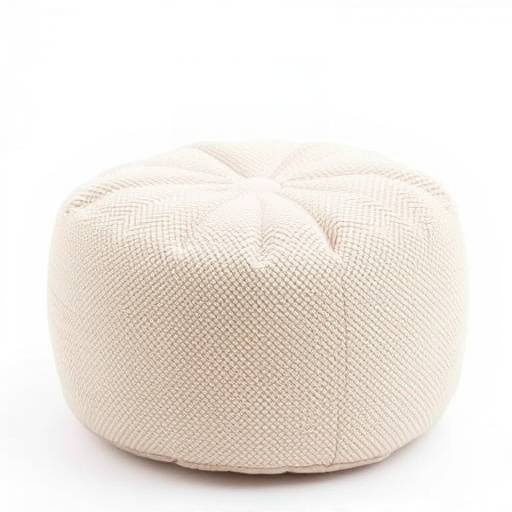 A small, round pouf upholstered in a textured beige fabric, perfect as a footrest or extra seating